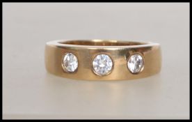 A hallmarked heavy 9ct gold ring having  three CZ stones  in a bezel setting. Hallmarked