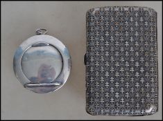 A silver tested ladies vanity compact of circular form having a hinged mirror lid revealing a