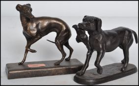 Two vintage style bronze effect cast iron dog figurines, one being a hunting retriever dog with