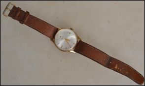 A 9ct gold gentleman's cased Incabloc wristwatch by Everite, the circular silvered dial with gold