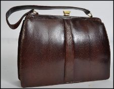 A vintage mid 20th century snakeskin handbag by Mappin & Webb Ltd retaining its original box and