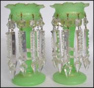 A pair of Victorian green glass serpent lustres. Each with green glass vases embellished with coiled