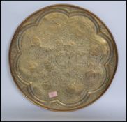 A vintage early 20th century Islamic / Turkish brass wall charger of circular form depicting kings