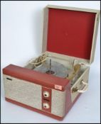 A vintage mid 20th century two tone Pilot Encore portable record player. Fitted with a four speed