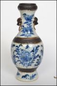 A Chinese blue and white crackled glaze vase having dogs of fu masks decorated with Peonies,