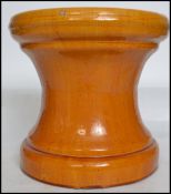 A vintage ceramic terracotta planter plant stand having a tapering base with a yellow glaze finish.