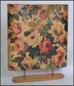 A vintage retro mid century chintzy floral fire screen with a built in back lit electrical light.
