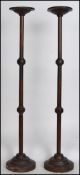 A pair of Victorian tall oak eclesiastical candle stick stands / prickers having raised on