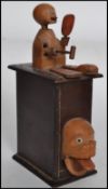 A 19th century Japanese Kobi wood box toy with novelty action, turn handle operates a head