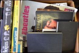 A large collection of The Beatles memorabilia to include puzzles, books, magazines, CDs,