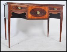 A 19th century Georgian mahogany inlaid sideboard / desk raised on squared legs being profusely