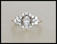 A hallmarked 9ct gold and CZ cluster ring . Hallmarked Birmingham . Weight 2.8g  . Size  L.