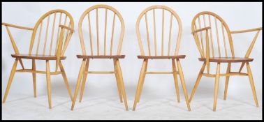 A set of four vintage 20th century retro Ercol light beech and elm dining chairs, two being carver