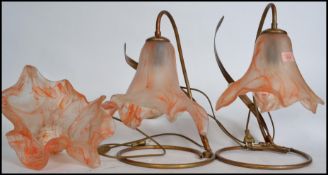 A pair of studio glass table lamps, raised on a gilt spiral tubular base, the studio hanker-chief