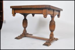 A vintage early 20th century Art Deco draw leaf oak extended dining table raised on carved twin legs