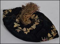 An early 20th century scholars cap complete with tassle and embroidered design with foliates