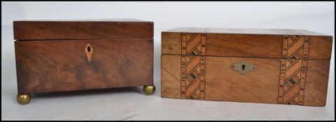 A Victorian 19th century flame mahogany workbox being raised on ball finials together with another