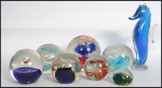 A collection of vintage studio art glass paperweight dumps to include inset marine diorama