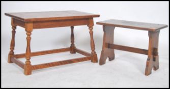 A vintage 20th century oak concessional table raised on splayed turned legs united by stretchers