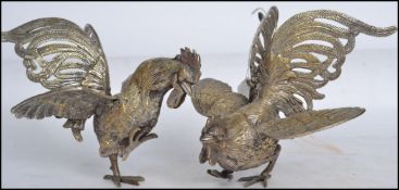 A 20th century pair of good silver plate fighting cocks - cockerel, both in differing aggressive