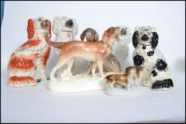 A group of 19th century Staffordshire flat back fireside dog figurines along with a dachshunds