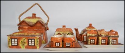 A good collection of ceramic cottage wear pottery to include teapot, biscuit barrel, egg cups on