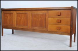 A vintage retro 20th century teak wood Danish inspired sideboard having a series of drawers and