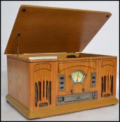A vintage style wooden cased vinyl record, CD player and radio having a hinged lid to top and