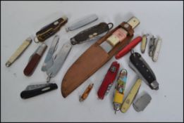 A collection of vintage military and other pen knives to include a 1954 Korean war knife, horn