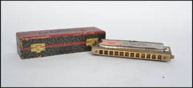 A vintage 20th century The Super Chromonica chromatic harmonica musical instrument by M Hohner No
