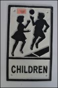 A vintage Worboys style cast iron children crossing motoring street sign depicting a boy and girl