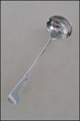 A unusual hallmarked silver Georgian miniature chocolate ladle having a rounded bowl with a