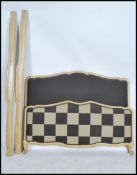 An early 20th century upcycled French corbeille bed with a contempory upholstered head and footboard