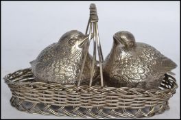 A silver plated table salt and pepper cruet set in the form of nesting birds the wicker work nest