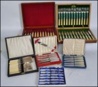 A cased set of hallmarked silver collared cutlery together with other cased flatware sets to include