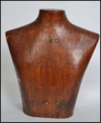 A vintage 20th century upper torso male mannequin of wooden construction having bold notation to