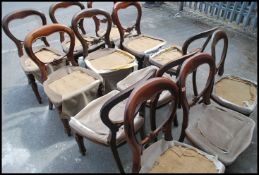 A long run / set of twelve 20th century mahogany balloon back dining chairs with upholstered seats