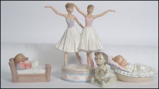 A collection of Nao and other ceramic figurines of children along with a pair of ballet dancers on a