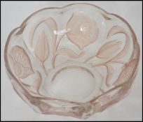 A 1920's pressed iridescent glass fruit bowl in th