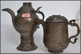 A pair of believed 18th century Islamic teapot / coffee pots. Each with stunning hammered