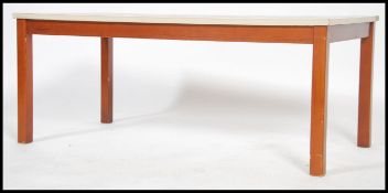 A 1970's retro teak wood and faux formica tile top coffee table being of rectangular form and raised