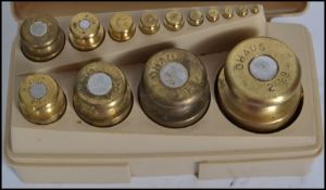 A set of vintage 20th century brass weights of cylindrical form by OHAUS complete in original box.