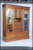 A VIctorian walnut triple inverted breakfront wardrobe compactum having twin mirror door wardrobes