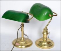 A near pair of vintage style 20th century bankers desk lamps having green glass shades raised on