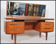 A 1970's G-Plan teak wood dressing table in the manner of Mogens Kolo. The dressing table raised