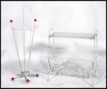 A retro vintage 20th century atomic sputnik umbrella stand in white having red ball final ends along