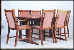 A 1960's retro Danish teak D - end extending dining table, with six matching teak wood dining chairs