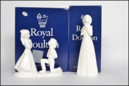 A boxed Royal Doulton Image of the Year 1999 The Promise along with another figure God Bless You