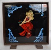 A vintage 1930s Art Deco table top discretionary screen having a painted glass panel with maiden