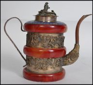 A very unusual silver on copper Oriental teapot having a shaped handle and spout having